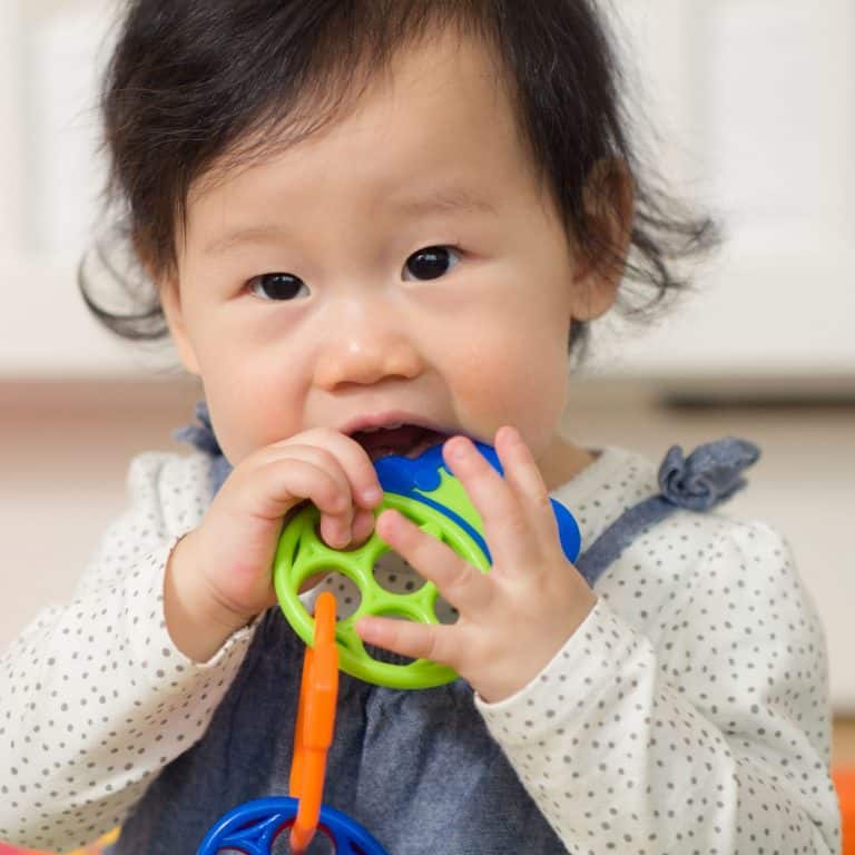 baby chewing on a teether
